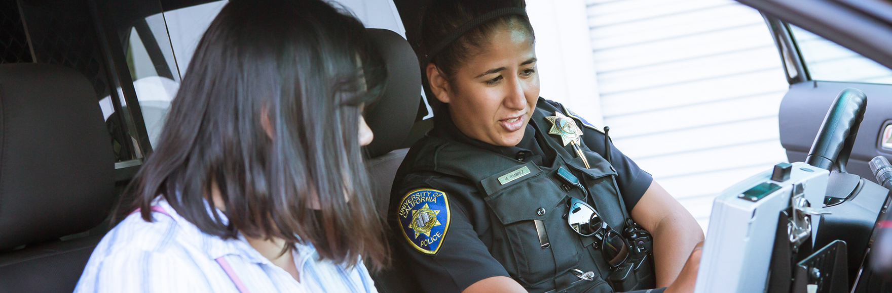 Officer showing a community member the patrol car