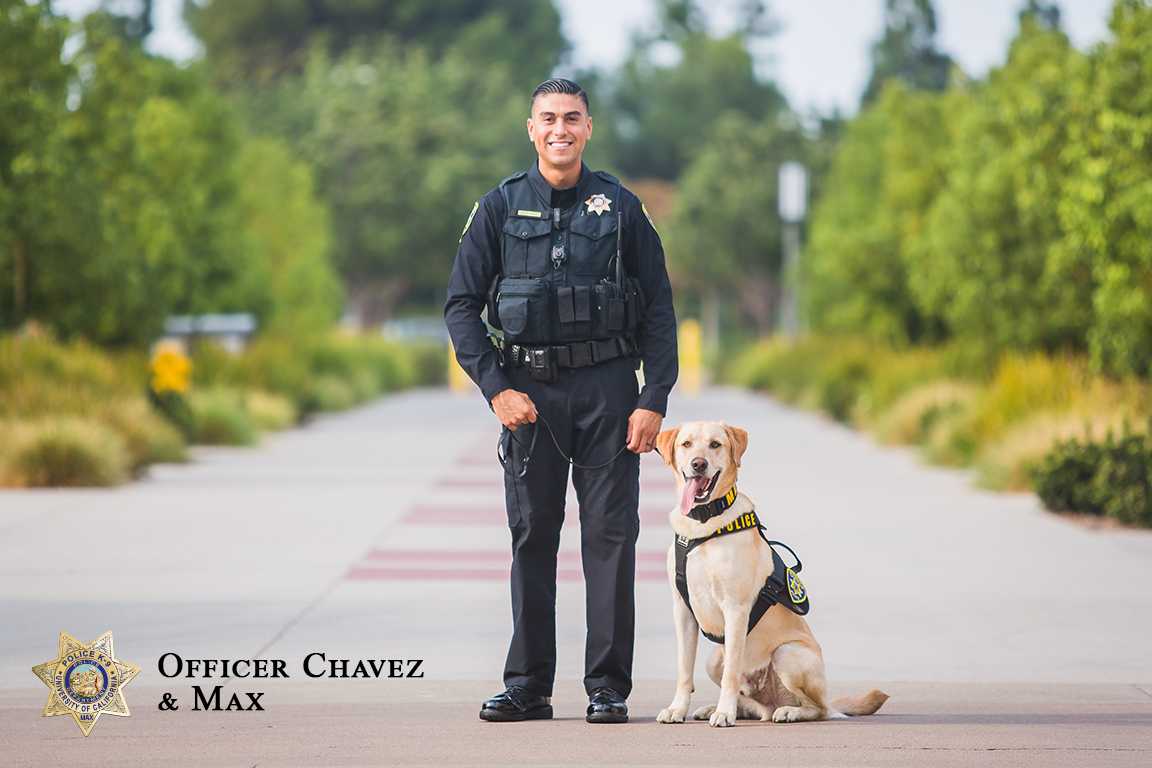 A photo of Officer Chavez smiling with Max the K-9 sitting beside him